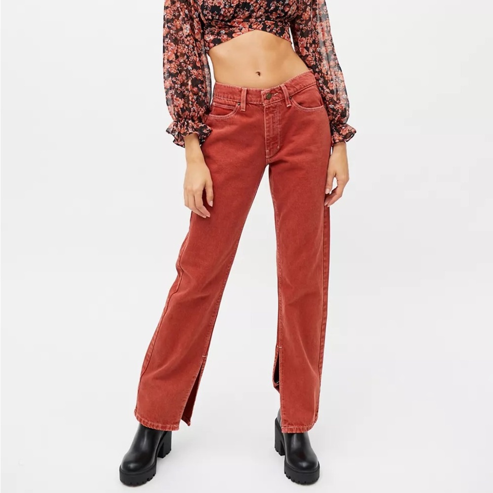 BDG high-waisted orange denim jeans with split hem at bottom